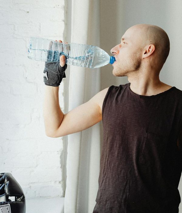 Man performing a controlled strength exercise in a well-lit space.